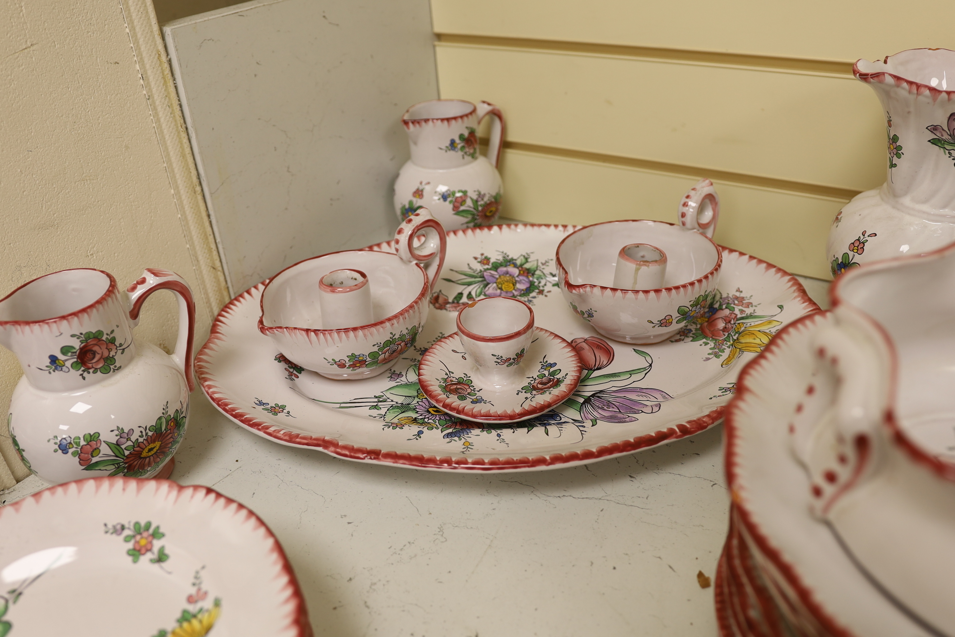 Le Renoleau Faiencerie D'Art, Angouleme, French faience tableware with floral decoration, including lidded serving pots, tureens, jugs, serving dishes, coasters, plates, candle stands, a candlestick, a water dispenser fo